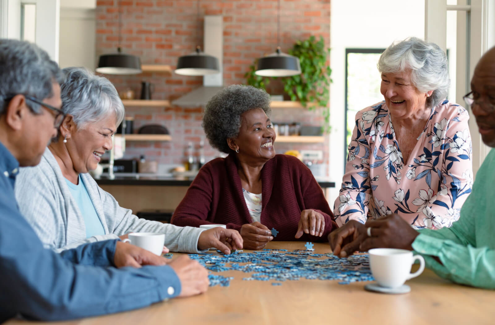 A group of older adults solving a jigsaw puzzle together.