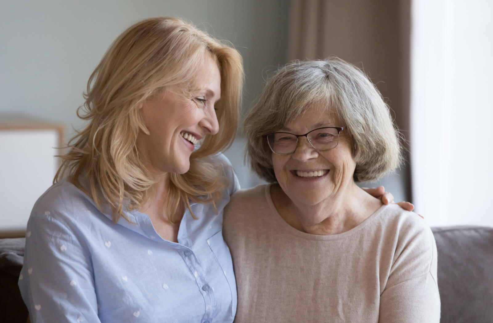 A senior woman smiling and talking to her daughter