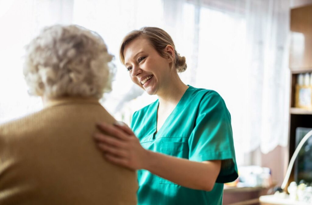 a caregiver supporting a senior in a personal care community